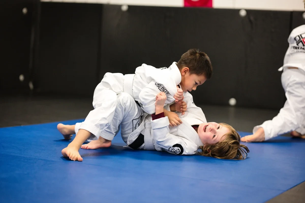 Kids practicing ground training techniques in BJJ at Yorkdale Martial Arts Academy