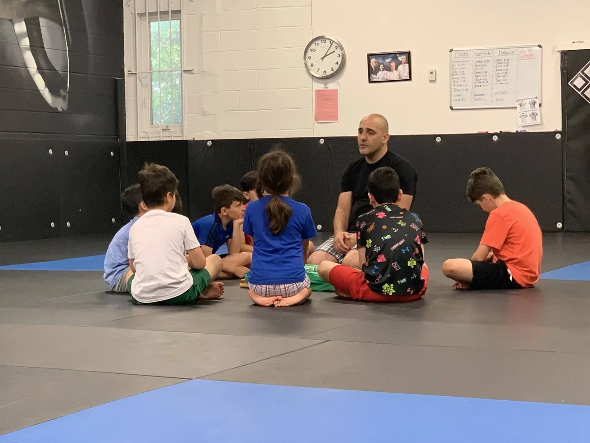 Kids doing warm-up exercises at martial arts summer camp near Toronto